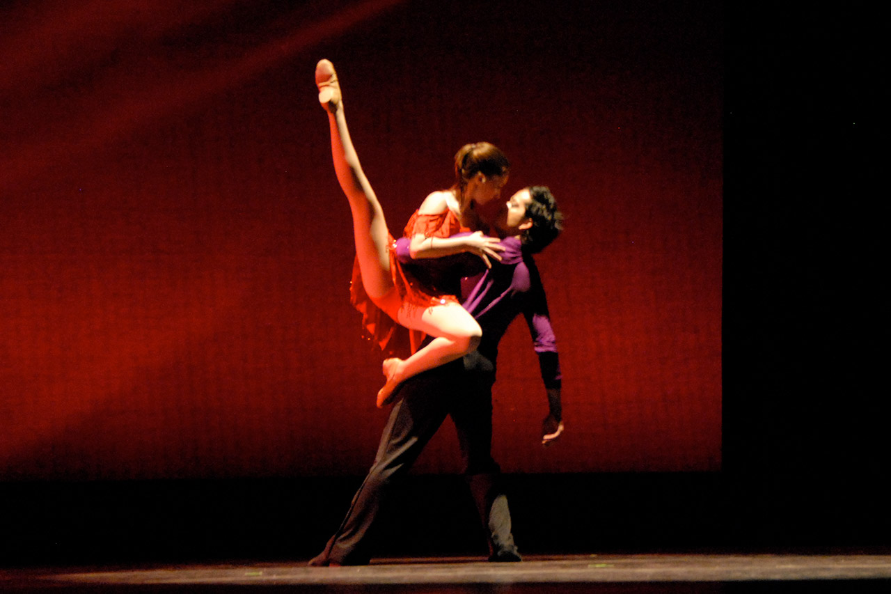 Two dancers tango on stage